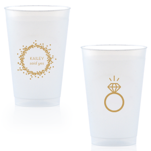 Cheers to the newly betrothed with the Engagement Ring Cup, bursting with celebratory bubbles and a bright 'said yes.' Flip to reveal a sparkling solitaire ring, toasting to the promise of a dazzling future together.