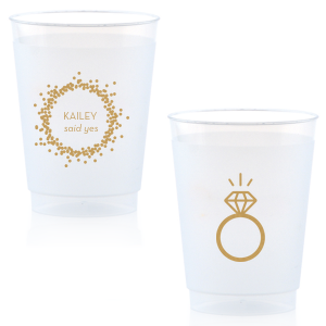 Cheers to the newly betrothed with the Engagement Ring Cup, bursting with celebratory bubbles and a bright 'said yes.' Flip to reveal a sparkling solitaire ring, toasting to the promise of a dazzling future together.