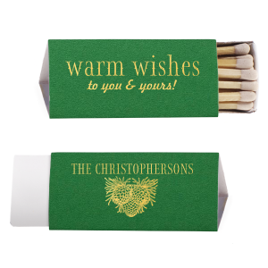 Ignite a hearthside glow with the Warm Wishes Matchbox, extending a toasty greeting to all. The family name and pinecone cluster on the reverse side kindle the essence of homely cheer, perfect for fireside gatherings and festive nights.