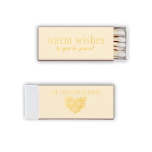 Ignite a hearthside glow with the Warm Wishes Matchbox, extending a toasty greeting to all. The family name and pinecone cluster on the reverse side kindle the essence of homely cheer, perfect for fireside gatherings and festive nights.