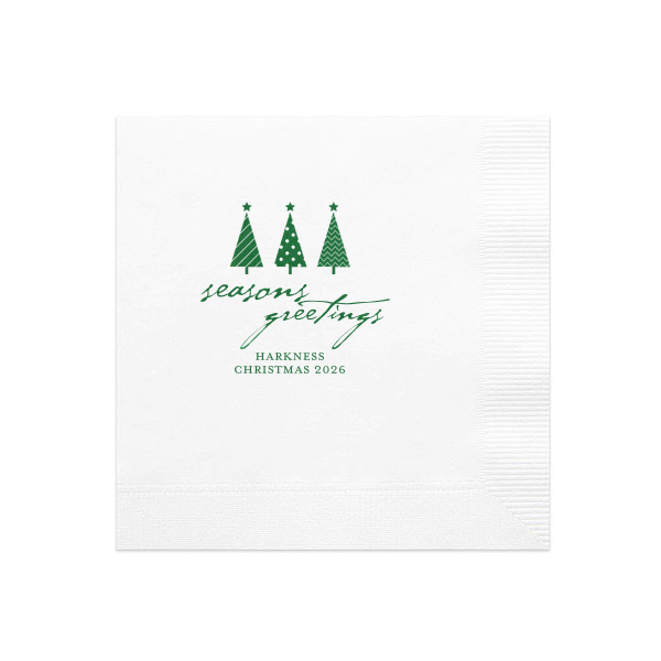 Spruce up your holiday table with the Seasons Greetings Christmas Tree Napkin, where a trio of distinctively decorated trees shines brightly. 'Seasons Greetings' unfurls in joyful script, inviting guests to share in the festive cheer of your celebration.