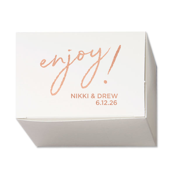 Invite a burst of happiness with the Enjoy! Favor Box. The design centers around a playful “Enjoy!” in whimsical, lower-case script, exuding an air of fun and excitement. Beneath this cheerful exclamation, the couple’s names and the celebration date add a personal touch, making this favor box a delightful parting gift to their guests. "