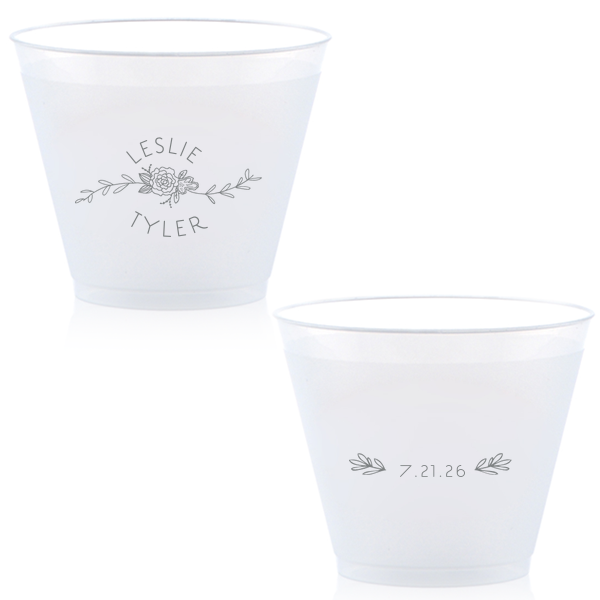 Captivate your guests with the Peony Flourish Names Frosted Cup, featuring a charming heart-leaf flourish and a central peony. This elegantly stacked design beautifully intertwines the couple's names, creating an air of sweet simplicity and sophistication for your memorable celebration.