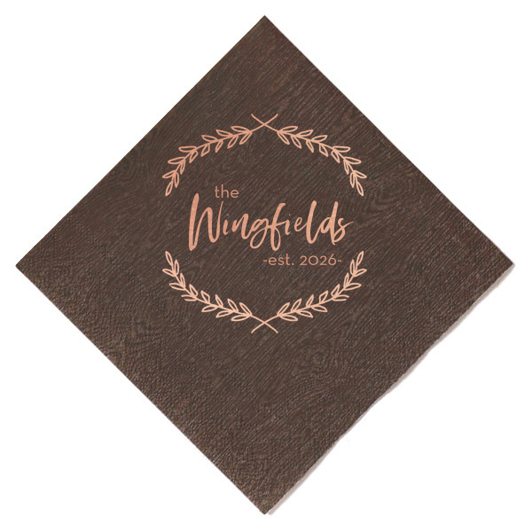 The Foliage Framed Family Napkin exudes timeless elegance with a delicate garland encircling your family's surname, crowned with the "established" year. This richly hued napkin becomes a classic keepsake for weddings or housewarmings, celebrating both new beginnings and established bonds with sophistication.