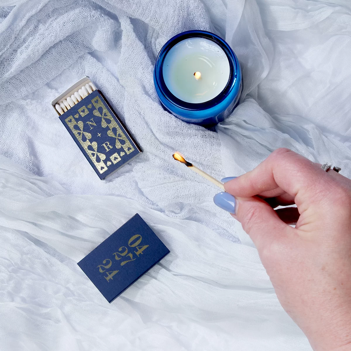 Navy blue custom matchboxes with lit match