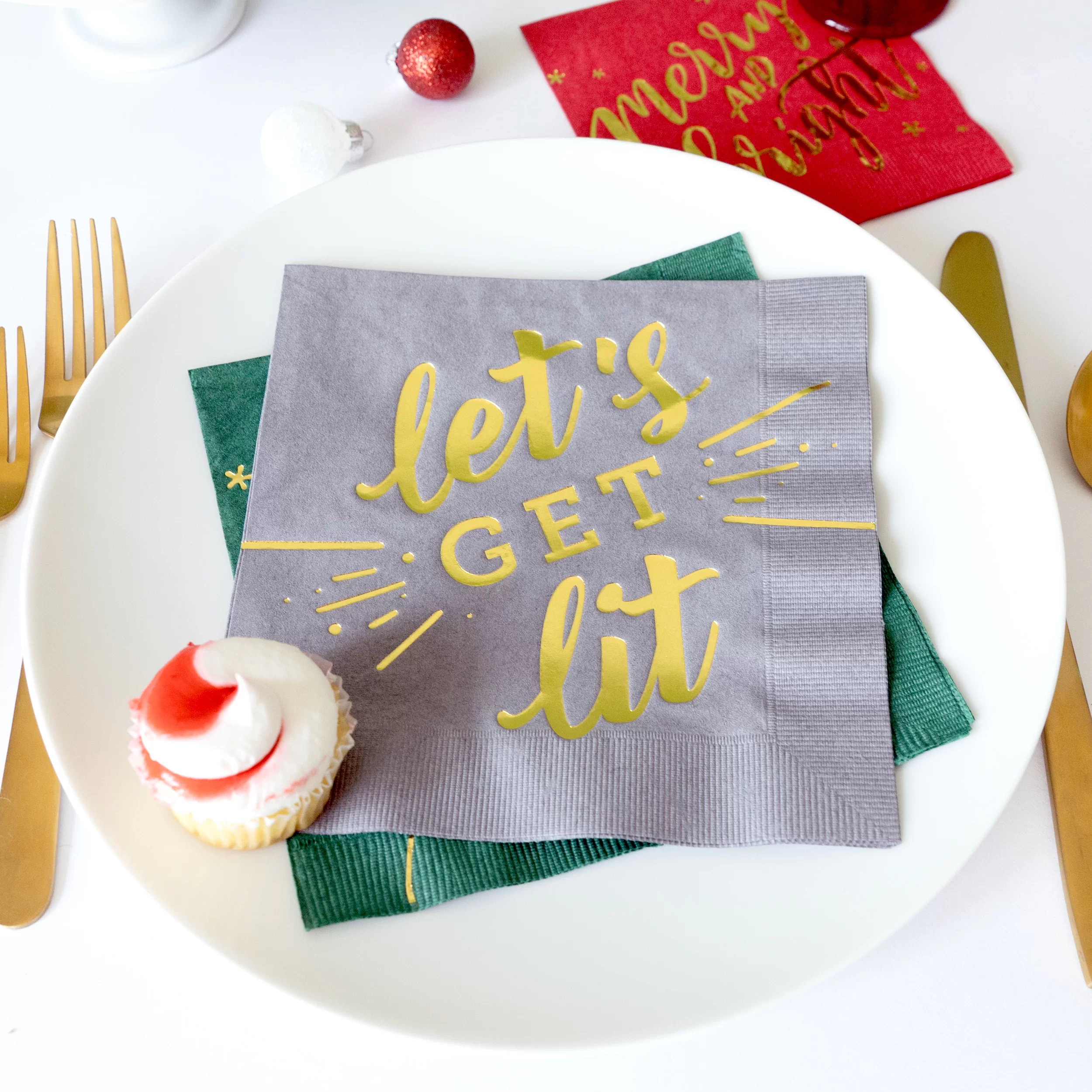 Let's get lit napkin on a plate with a mini cupcake