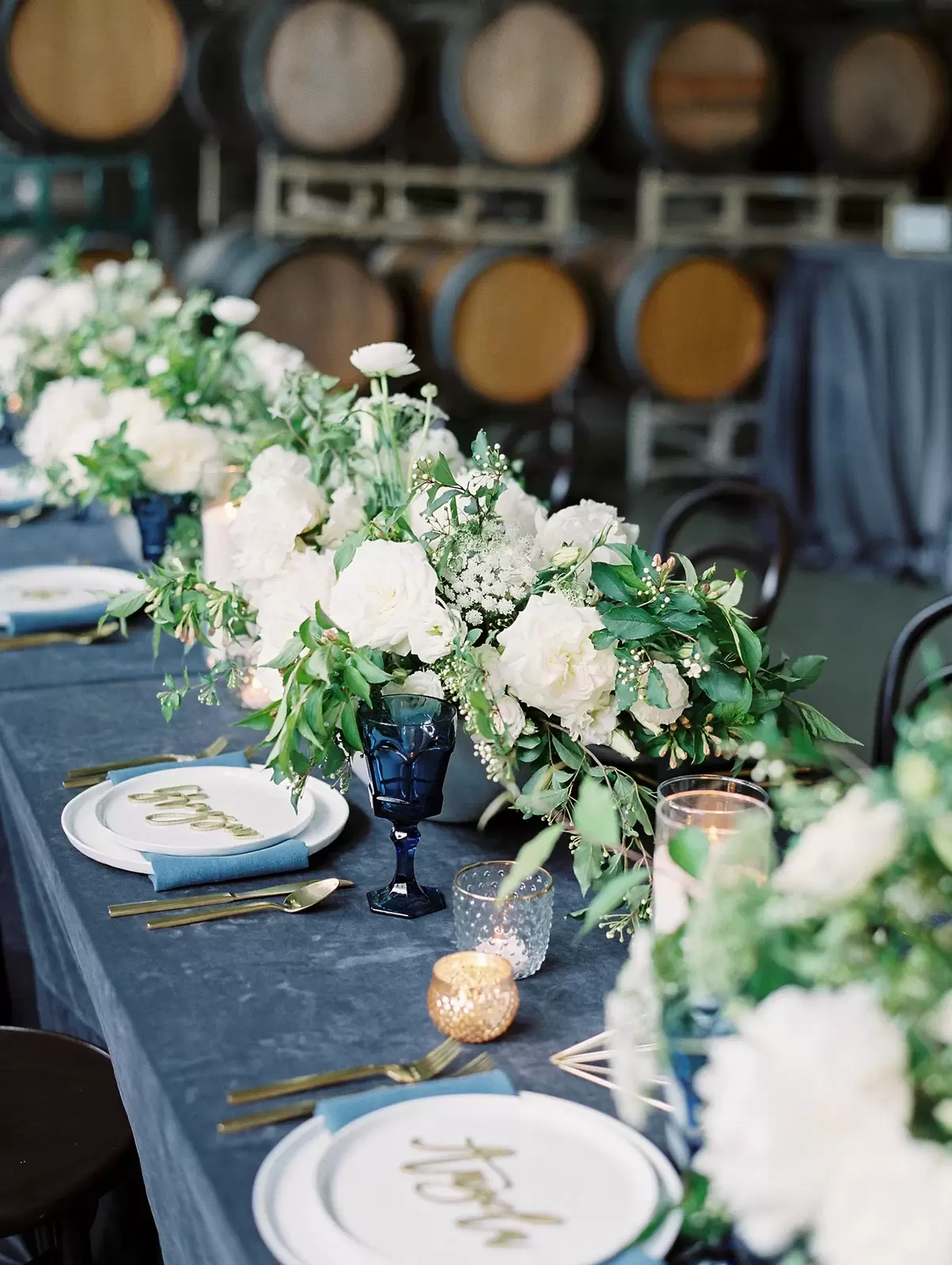 industrial glam table setting with colored glasses, laser cut names and garland table runner