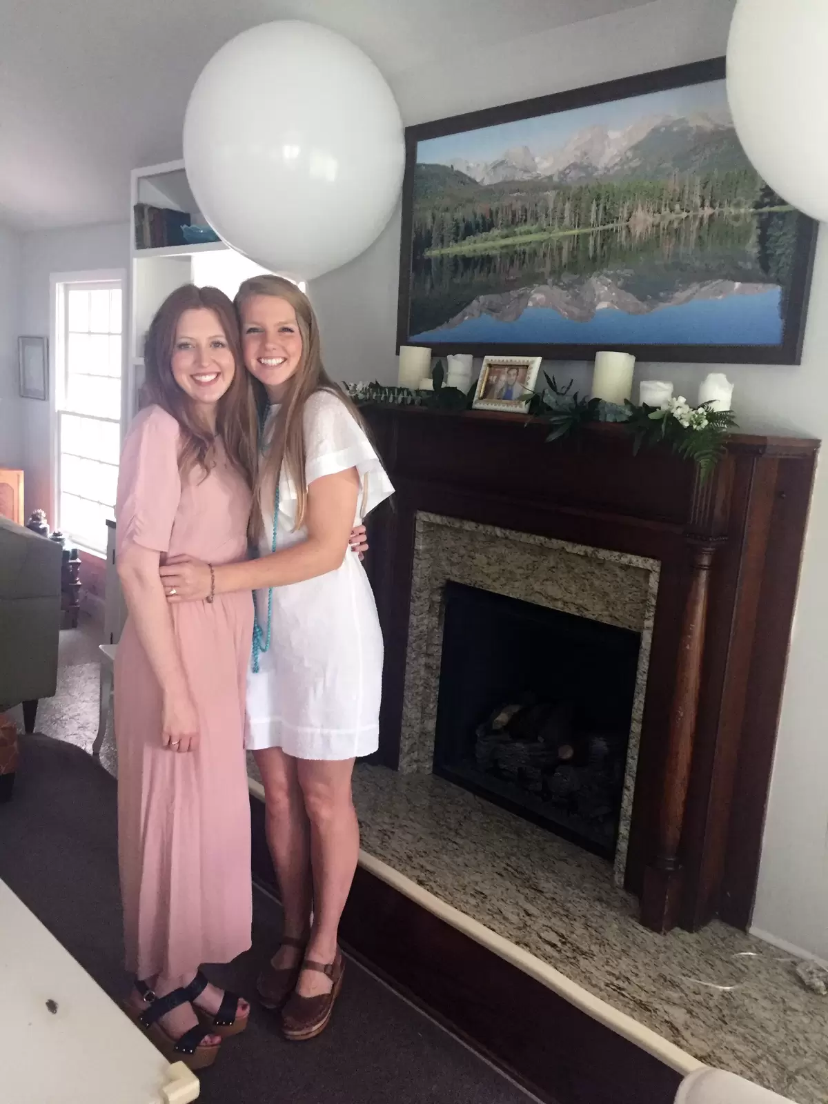 bride and bridesmaid at greenery themed kitchen bridal shower
