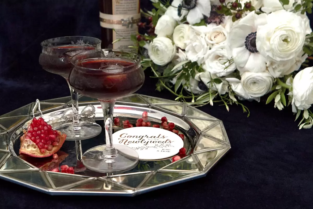 bourbon pomegranate manhattan cocktail recipe with custom coasters