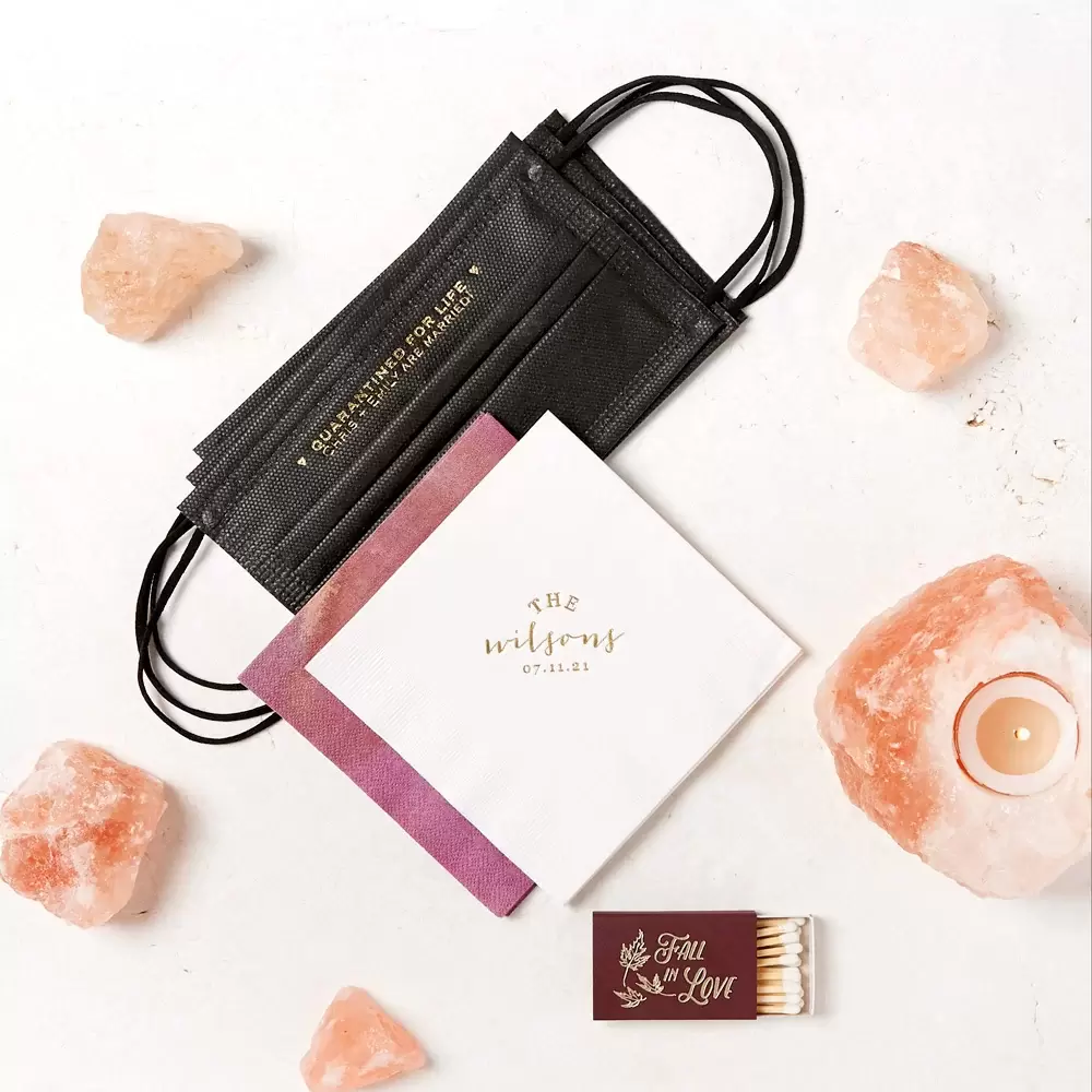 Custom designed cocktail napkins, disposable face masks and hand sanitizers are a 2021 wedding essential.