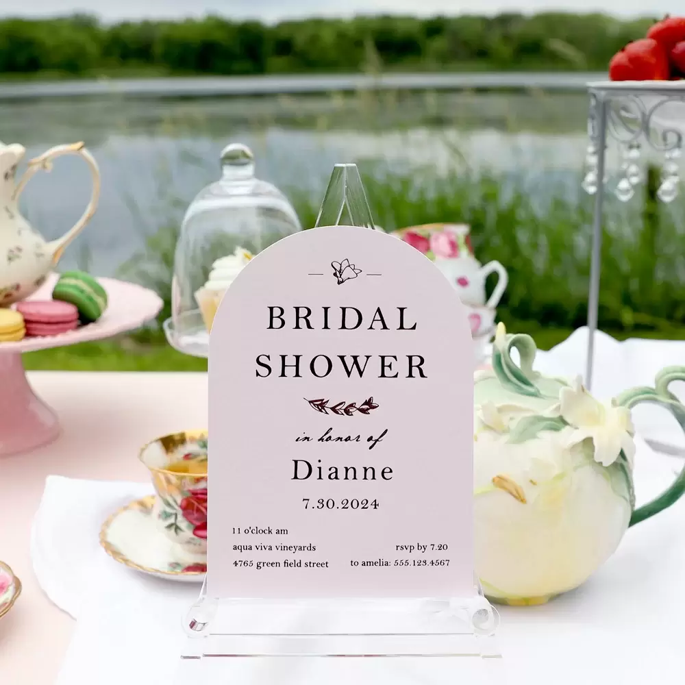 Close up of pink Arch Invite that says Bridal Shower in honor of Dianne