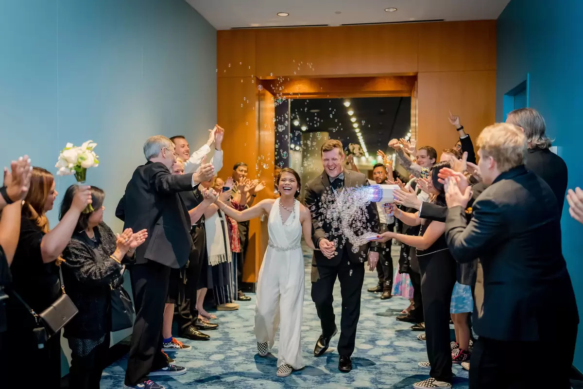 people cheering newlyweds at a semi formal wedding