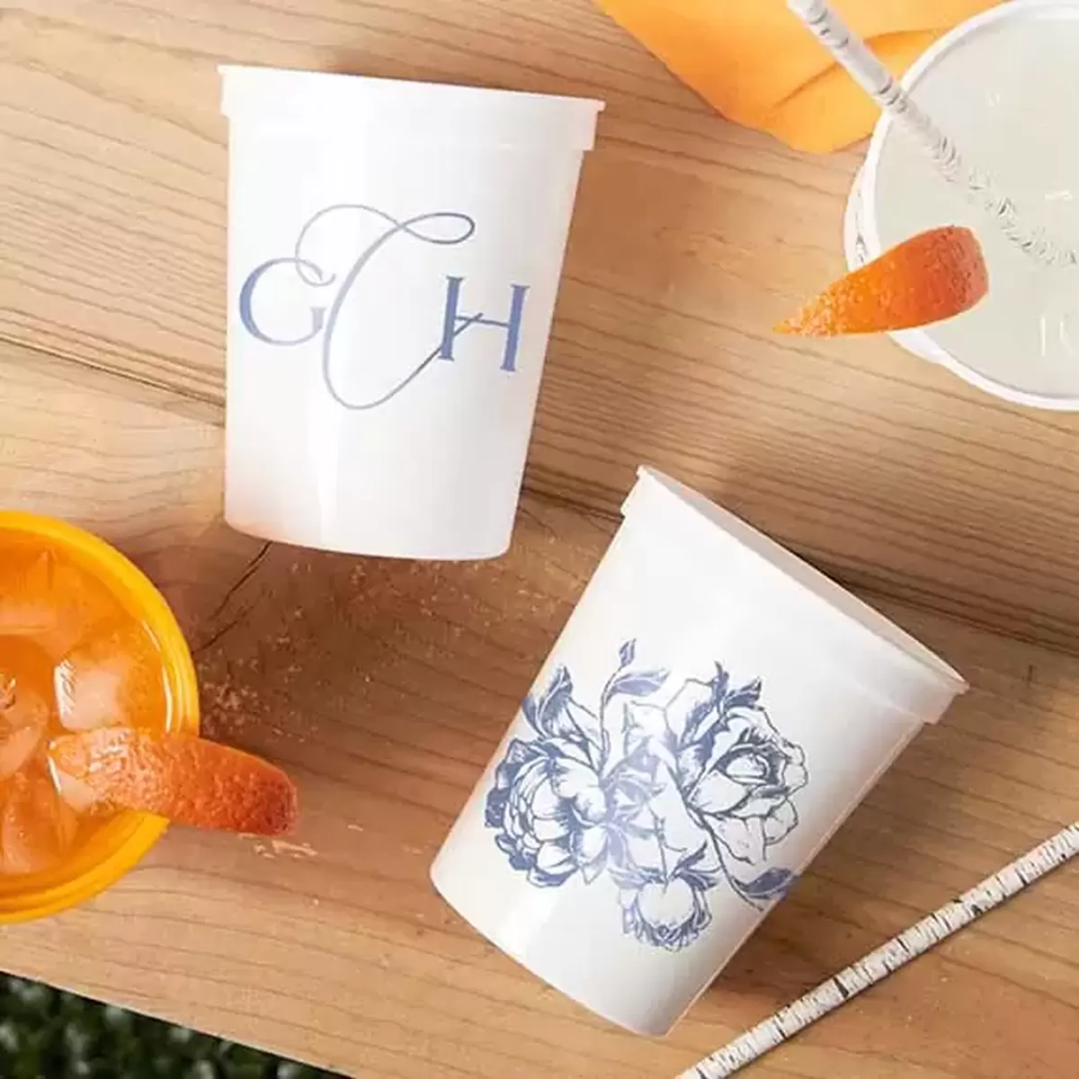 2 sided white stadium cups with monogram and rose designs in matte royal blue ink