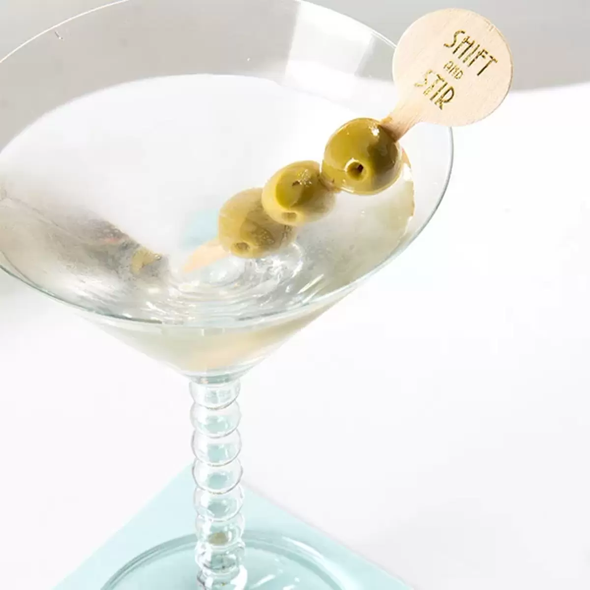 dirty martini with custom cocktail stirrer