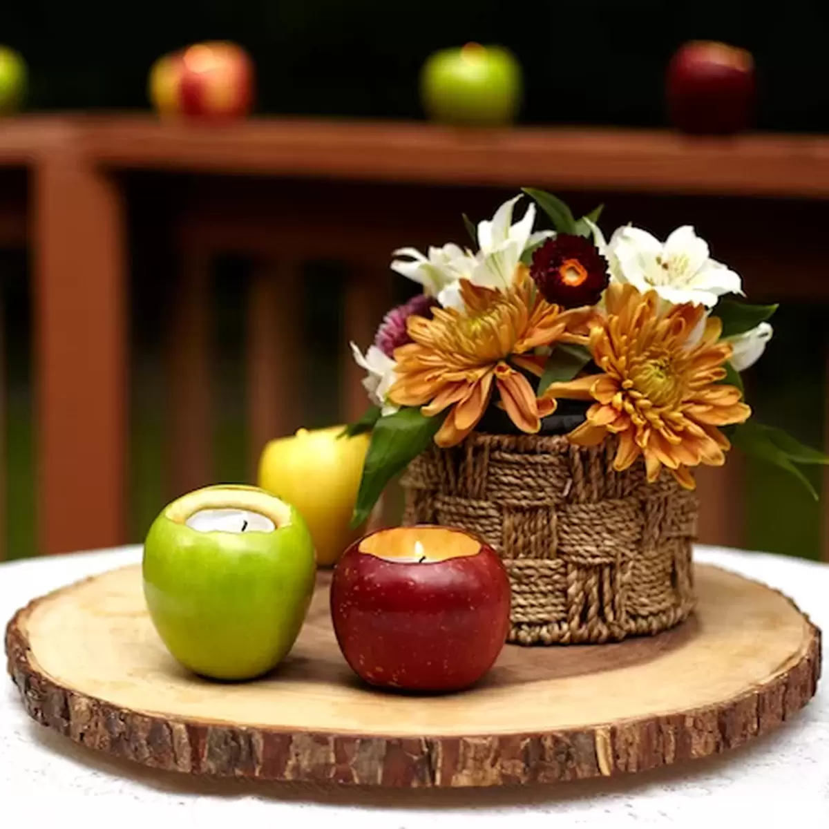 fall centerpiece with apples, flowers and diy votive candle holders